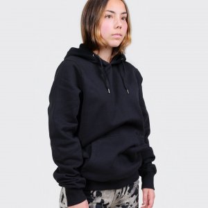 Model wearing unisex black two tone hoodie with subtle black skewed log